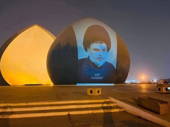 Muqtada al-Sadr’s image is projected onto Baghdad’s Martyr’s Monument.
