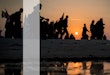 Silhouettes of crowded people walking at sunset time toward Karbala in Iraq for visiting the Holy Shrine of Imam Hussain