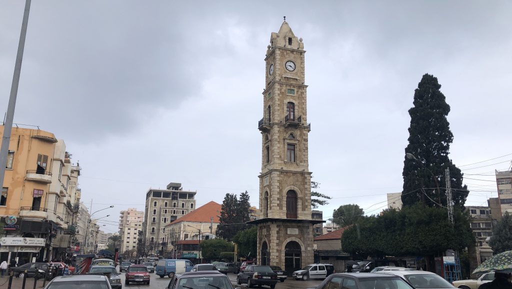 The clock tower in Tripoli’s Tall Square, with the city’s iconic Mercedes taxis below.