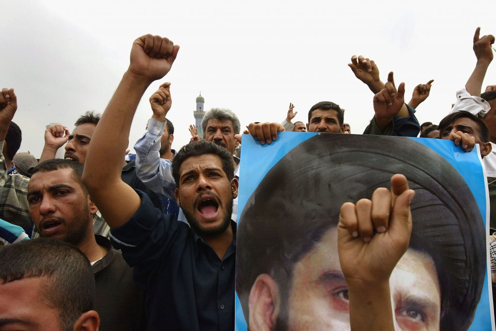 Protesters chant during a demonstration to protest the U.S.-led coalition’s closure of weekly Al-Hawza newspaper, run by followers of Muqtada al-Sadr, on April 4, 2004, in Baghdad. The labeling of Shia Islamist groups as “anti-state” has roots in narratives that grew in the first few years after the U.S.-led invasion of 2003.