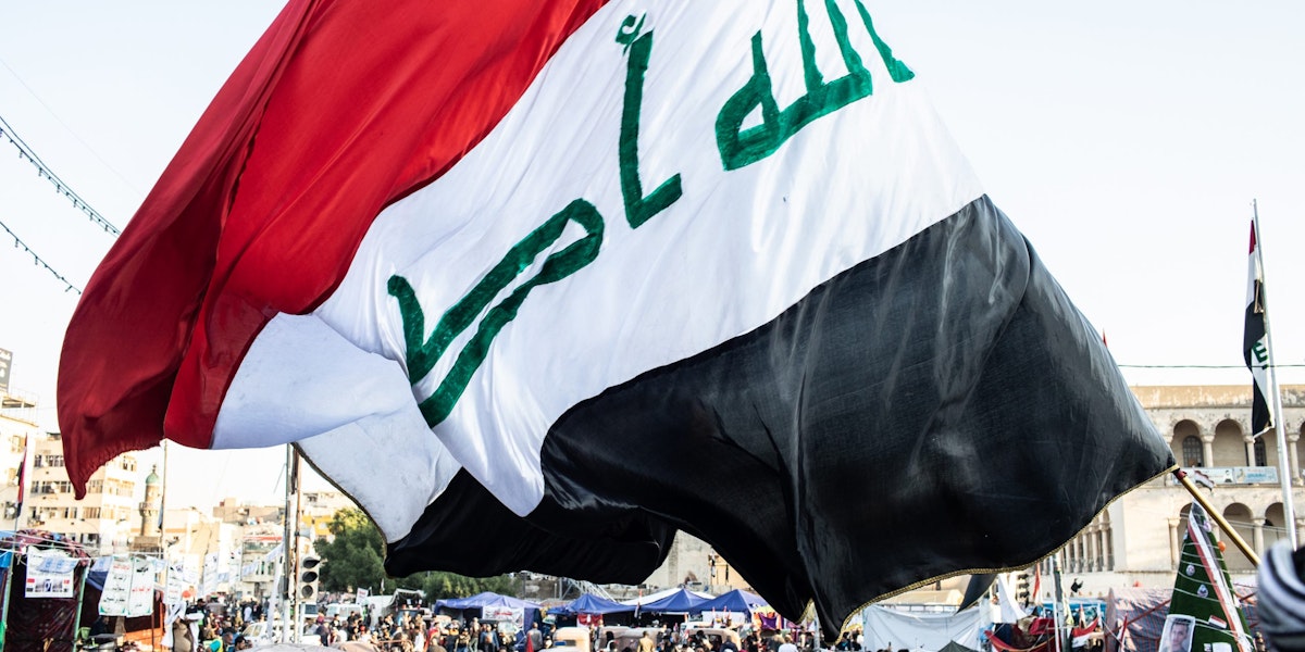 BAGHDAD, IRAQ - NOVEMBER 21: A flag waves over Tahrir Square on Nov. 21, 2019 in Baghdad, Iraq. Thousands of demonstrators have occupied Baghdad's center Tahrir Square since October 1, calling for government and policy reform. For many, Tahrir Square - which demonstrators are calling