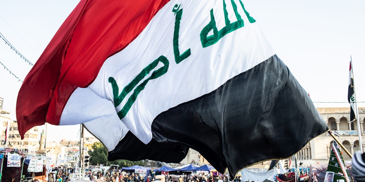BAGHDAD, IRAQ - NOVEMBER 21: A flag waves over Tahrir Square on Nov. 21, 2019 in Baghdad, Iraq. Thousands of demonstrators have occupied Baghdad's center Tahrir Square since October 1, calling for government and policy reform. For many, Tahrir Square - which demonstrators are calling 