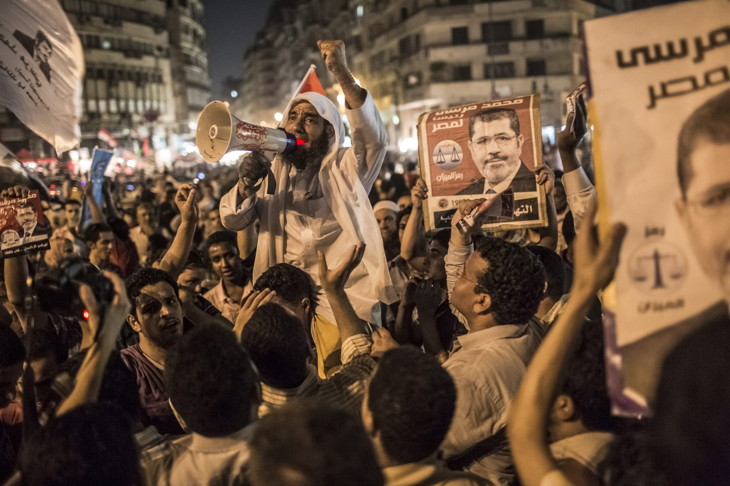 CAIRO, EGYPT - JUNE 18: Egyptians supporters of the Muslim Brotherhood celebrate a premature victory for their presidential candidate Mohamed Morsi in Tahrir Square on June 18, 2012 in Cairo, Egypt. Egyptian candidates Mohamed Morsi and Ahmed Shafiq contested in the second round of voting for the country's president held over two days of voting last weekend. Despite official results not having been announced, the Muslim Brotherhood are claiming victory for their presidential candidate Mohamed Morsi as unofficial tallies suggested he had won a majority. (Photo by Daniel Berehulak /Getty Images)