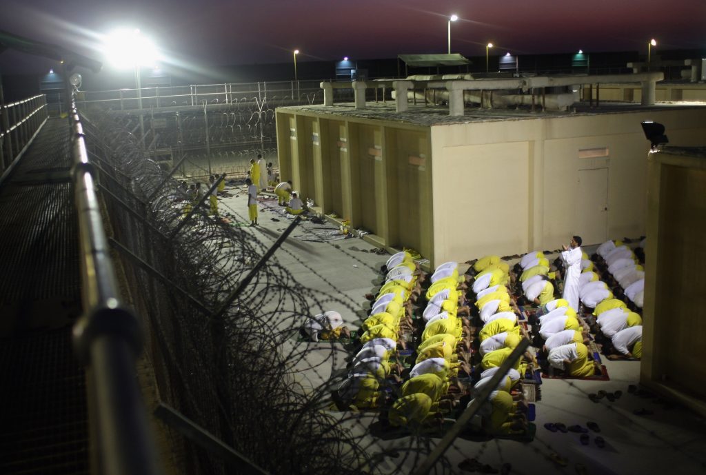 Iraqi detainees pray at the Camp Cropper detention center September 19, 2007, in Baghdad. Detainees at the time included insurgents from all anti-coalition groups in Iraq, foreign al-Qaeda fighters, and many innocent Iraqis caught up in U.S. military raids. Source: John Moore/Getty Images