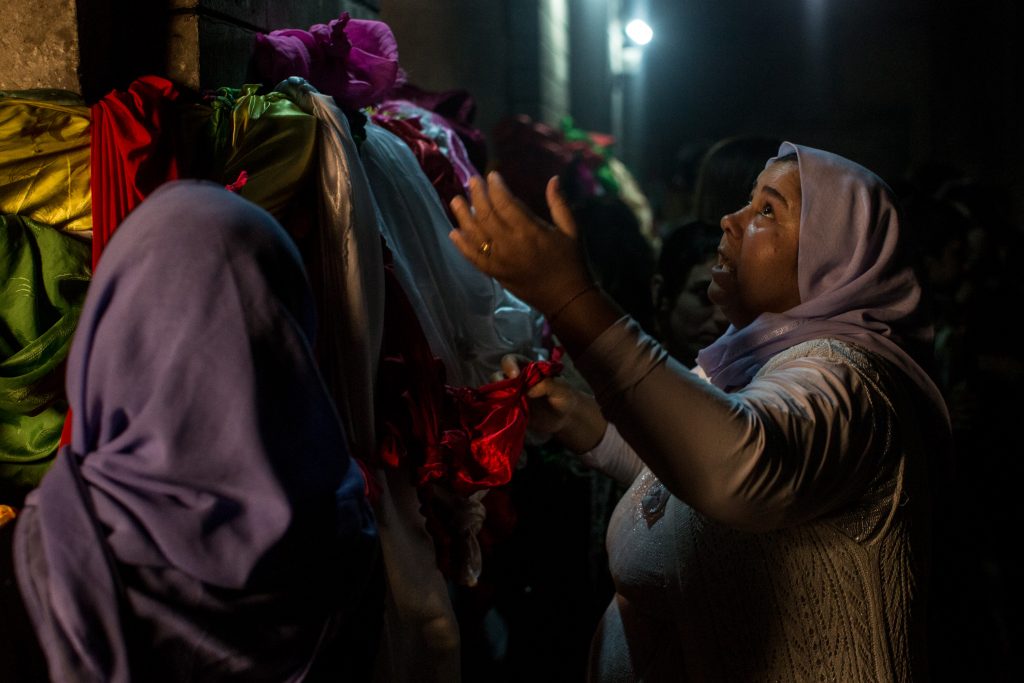 A Yazidi woman performs a religious ritual inside the holiest temple of the Yazidi faith while attending Friday rituals on November 11, 2016, in Lalish, Iraq. In 2014 thousands of Yazidis fled to the villages of Lalish and Shekhan after ISIS took control of Sinjar and other Yazidi-populated towns.