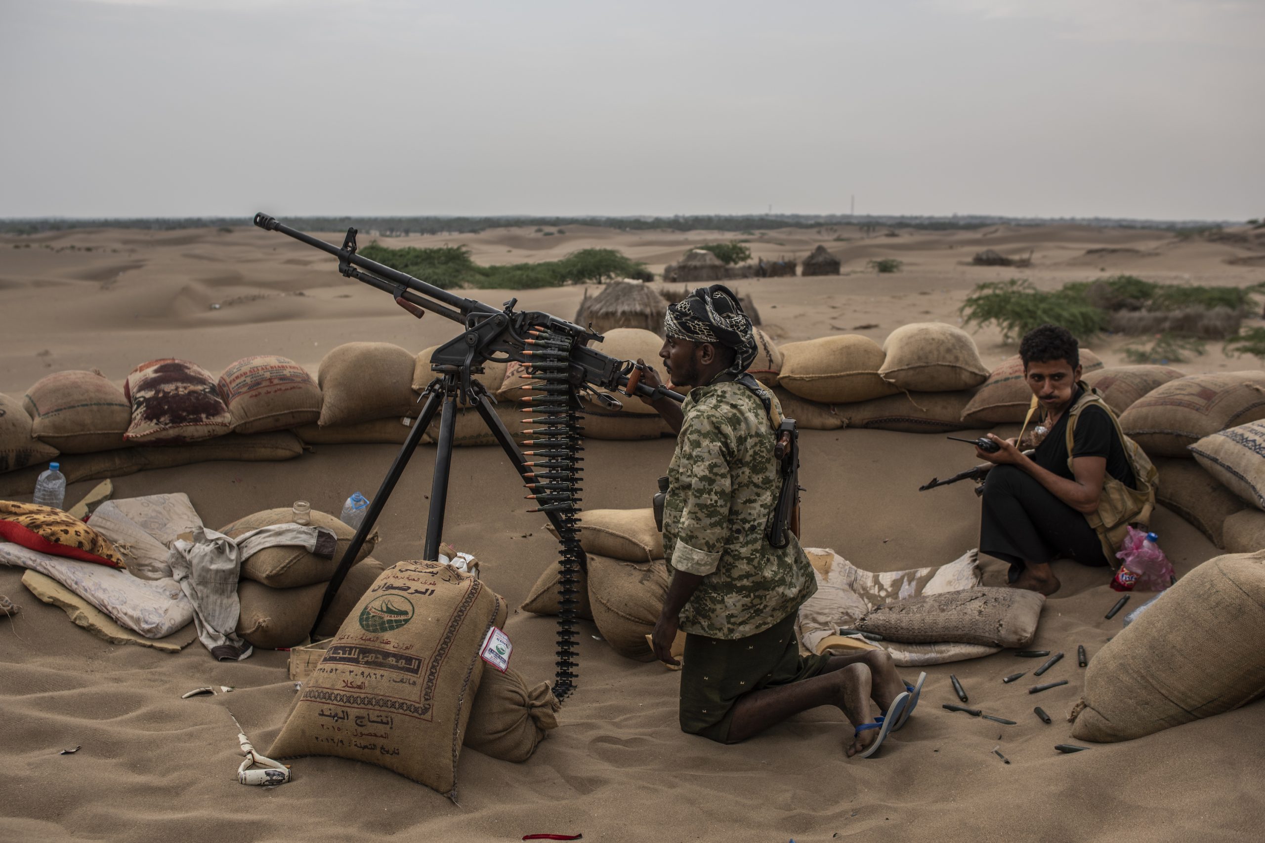 HODEIDAH, YEMEN - SEPTEMBER 20: Tahami Resistance fighters, a militia aligned with Yemen's Saudi-led coalition-backed government, rest after firing on Houthi rebel positions on a frontline east of the city on September 20, 2018 in Hodeidah, Yemen. A coalition military campaign has moved west along Yemen's coast toward Hodeidah, where increasingly bloody battles have killed hundreds since June, putting the country's fragile food supply at risk. (Photo by Andrew Renneisen/Getty Images)