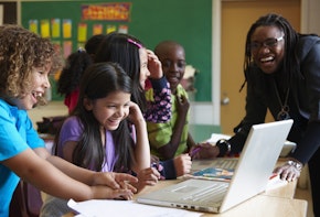 Students using laptop in classroom