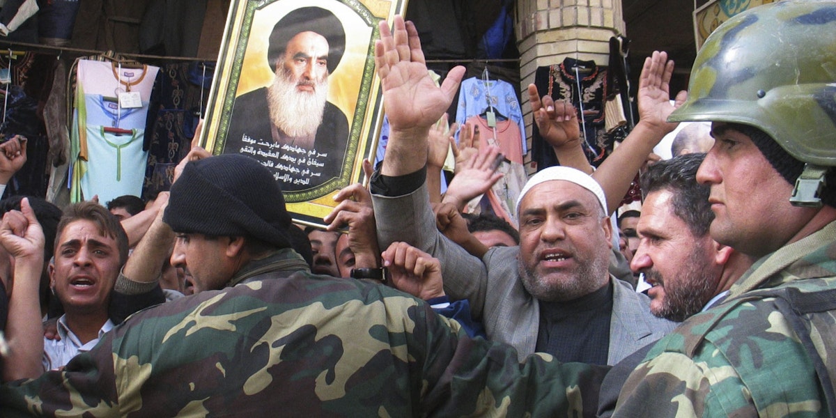 NAJAF, IRAQ - DECEMBER 17:  Iraqi soldiers try to control supporters of Iraq's Prime Minister Ibrahim al-Jaafari as they  welcome him on December 17, 2005 in the holy Shiite city of Najaf, Iraq. Al-Jaafari arrived in Najaf on December 17 and visited Ayatollah al-Sistani and the firebrand Shiite cleric Moqtada al-Sadr. (Photo by Saad Serhan /Getty Images)