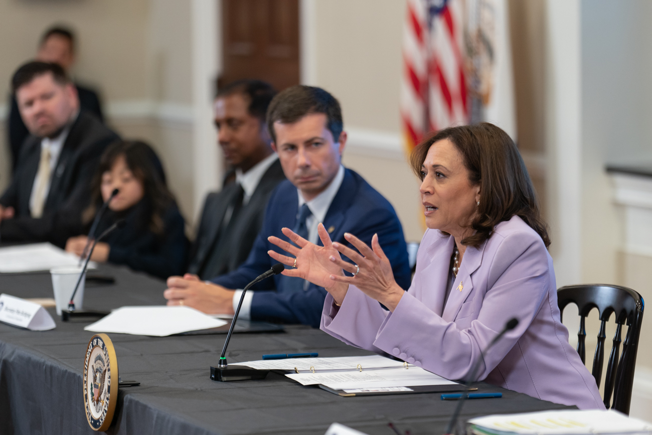 Vice President Kamala Harris and Pete Buttigieg sitting together on a panel.