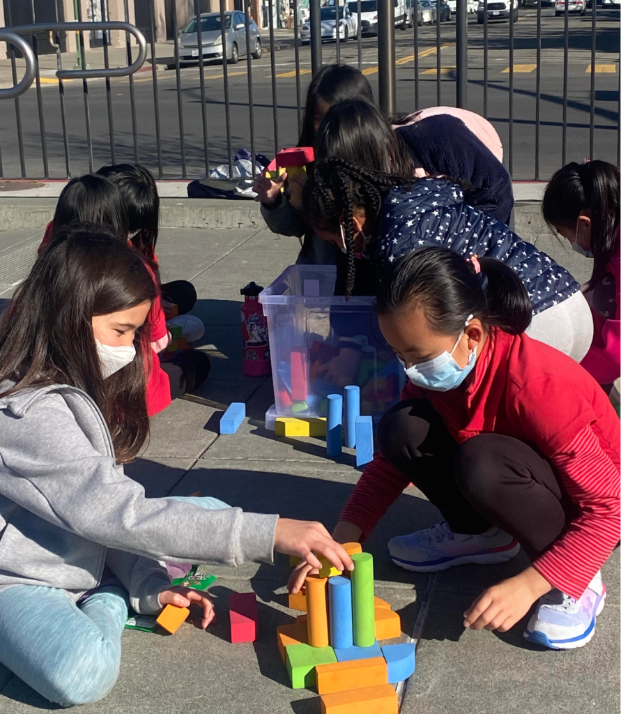 A group of students at Lincoln Elementary School play with equipment outside.