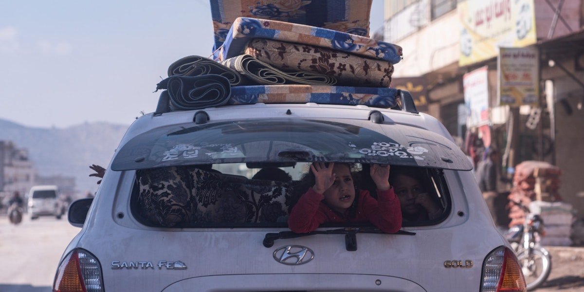 IDLIB, SYRIA - February 23 : A child sits in the back of the car while the family drive with their belongings, according to locals more than two million displaced because of war live in the northwest of Syria before the earthquake , on February 23, 2023 in Idlib, Syria. A 7.8-magnitude earthquake hit near Gaziantep, Turkey, in the early hours of February 6, followed by another 7.5-magnitude tremor just after midday. The quakes caused widespread destruction in southern Turkey and northern Syria and has killed more than 40,000 people. (Photo by Abdulmonam Eassa/Getty Images)