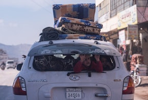 IDLIB, SYRIA - February 23 : A child sits in the back of the car while the family drive with their belongings, according to locals more than two million displaced because of war live in the northwest of Syria before the earthquake , on February 23, 2023 in Idlib, Syria. A 7.8-magnitude earthquake hit near Gaziantep, Turkey, in the early hours of February 6, followed by another 7.5-magnitude tremor just after midday. The quakes caused widespread destruction in southern Turkey and northern Syria and has killed more than 40,000 people. (Photo by Abdulmonam Eassa/Getty Images)