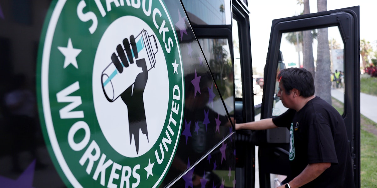 A Starbucks worker boards the Starbucks union bus after Starbucks workers stood on the picket line with striking SAG-AFTRA and Writers Guild of America (WGA) members in solidarity outside Netflix studios on July 28, 2023 in Los Angeles, California.