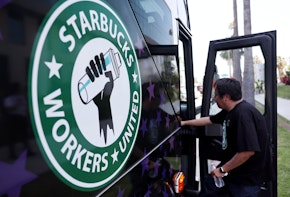 A Starbucks worker boards the Starbucks union bus after Starbucks workers stood on the picket line with striking SAG-AFTRA and Writers Guild of America (WGA) members in solidarity outside Netflix studios on July 28, 2023 in Los Angeles, California.