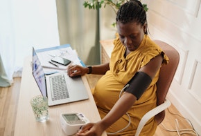 Pregnant woman working in her office