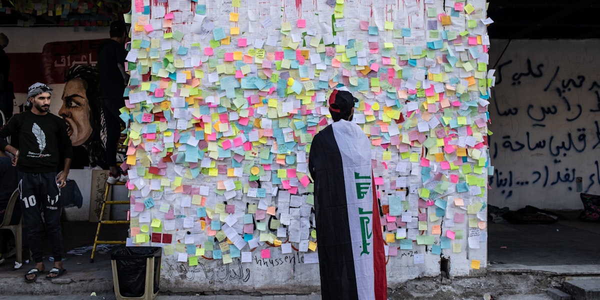 BAGHDAD, IRAQ - NOVEMBER 22:  Demonstrators pastes wishes on post-it notes on the 
