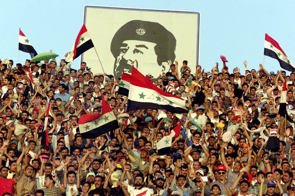 Baghdad residents cheer for their soccer team April 17, 2001 under a painting of a Iraqi President Saddam Hussein. Portraits of the Iraqi dictator, whose birthday is on April 28, adorned many of the buildings in the country's capital. Source: Karim Mohsen/Newsmakers via Getty Images