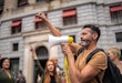 Mature man leading a demonstration using a megaphone