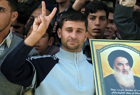 NAJAF, IRAQ - DECEMBER 17:  An Iraqi Shiite man shows getures and holds a picture of Grand Ayotallah Ali al-Sistani as he welcomes Prime Minister Ibrahim al-Jaafari December 17, 2005 in the holy Shiite city of Najaf, Iraq. Al-Jaafari arrived in Najaf on December 17 and visited Ayatollah al-Sistani and the firebrand Shiite cleric Moqtada al-Sadr. (Photo by Saad Serhan /Getty Images)