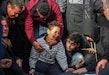 People mourn as they collect the bodies of Palestinians killed in an airstrike on December 20, 2023 in Khan Yunis, Gaza.