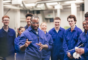artificial intelligence taking over jobs essay introduction A tutor teaches his class about renewable energy in an engineering workshop. They are all wearing protective eyewear and blue coveralls.