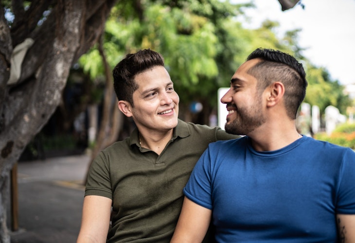 Gay couple talking and sitting at the historic district