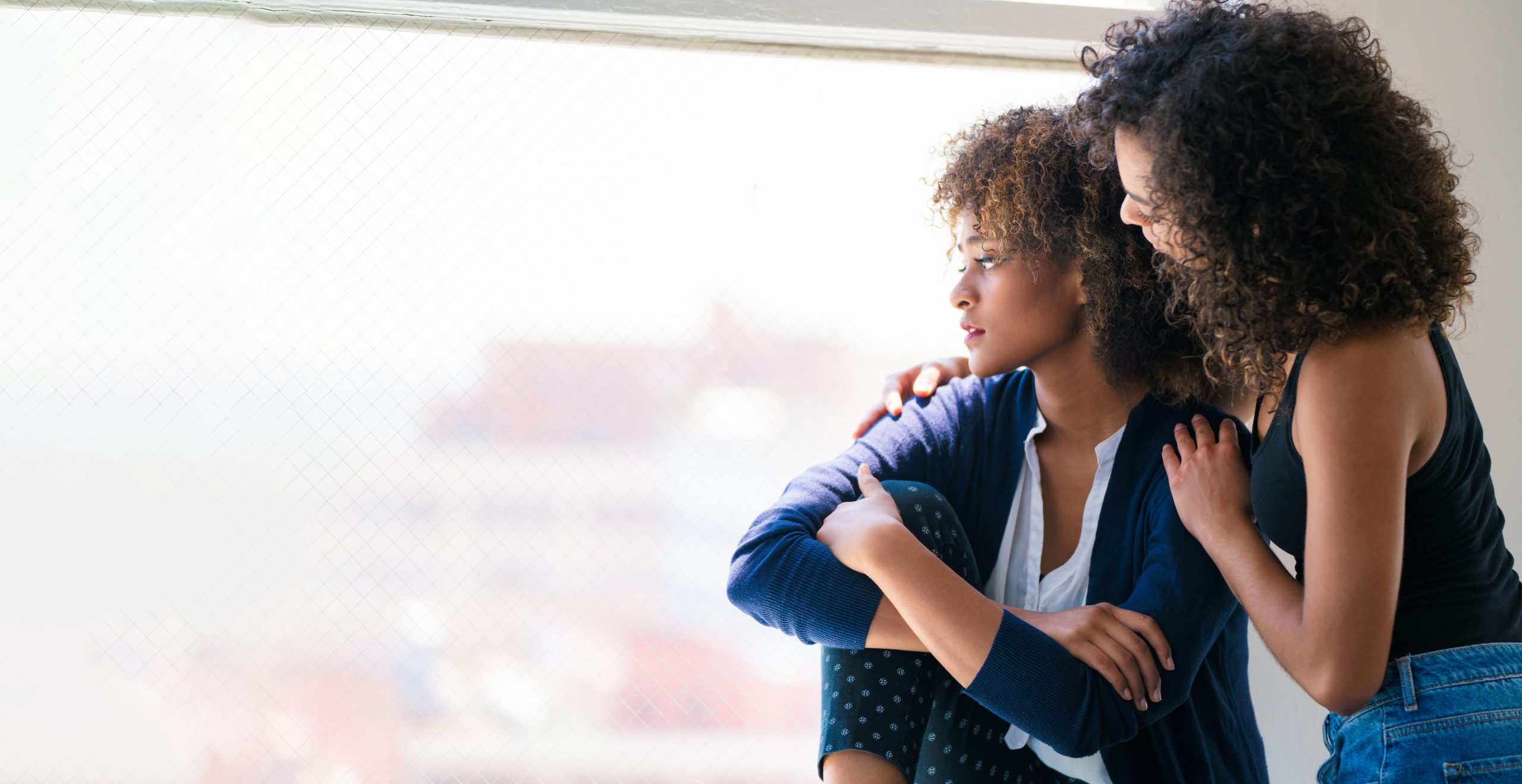 Young woman consoling her friend. Los Angeles, America. July 2017