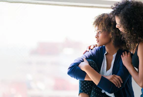 Young woman consoling her friend. Los Angeles, America. July 2017