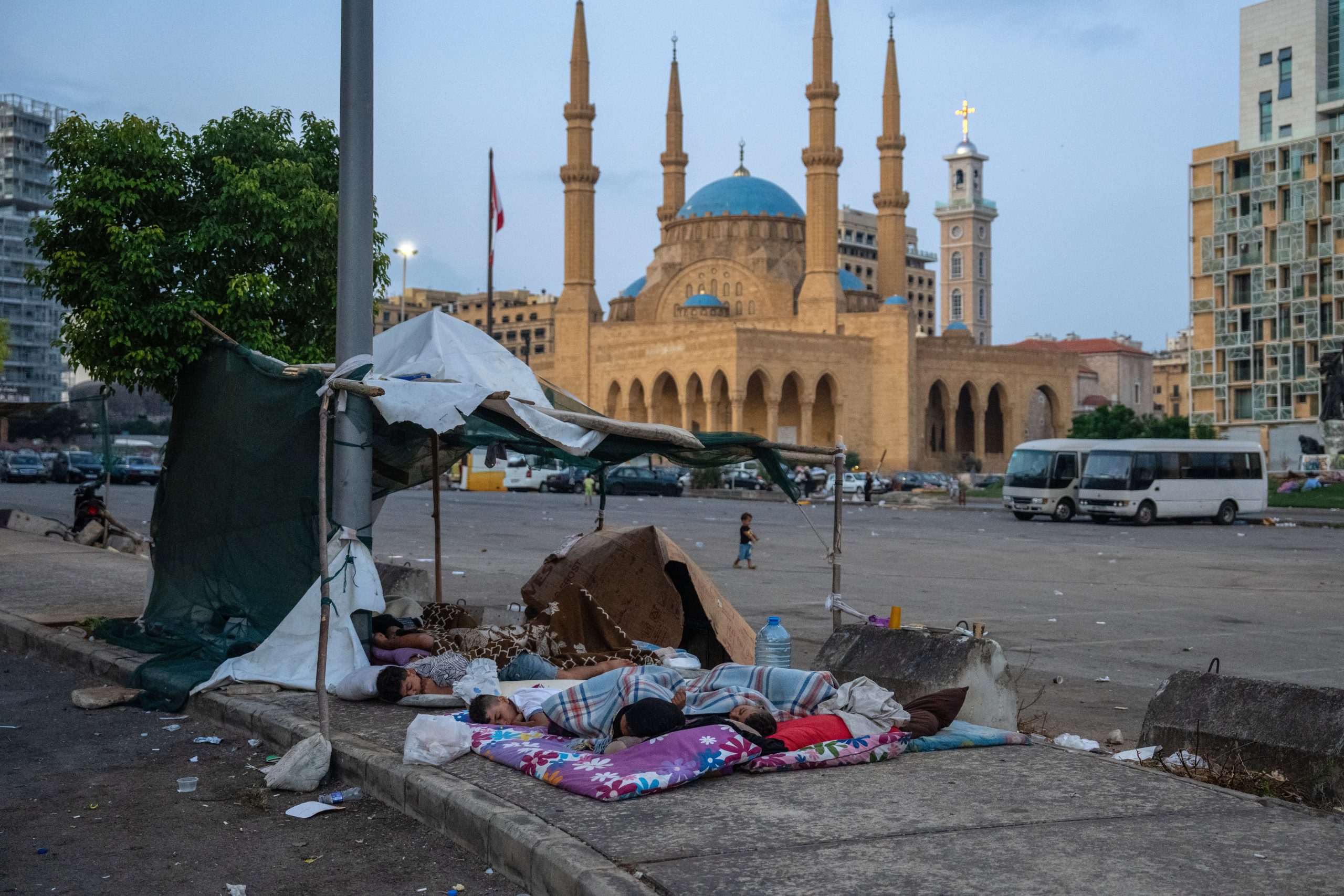 BEIRUT, LEBANON - OCTOBER 14: People sleep in the open in Martyrs' Square where they are sheltering after being displaced by the ongoing conflict with Israel, on October 14, 2024 in Beirut, Lebanon. Around 1.2 million people are believed to have been displaced by the ongoing conflict as the Israeli military expands its military operations across Lebanon. (Photo by Carl Court/Getty Images)