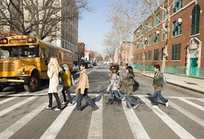 Teacher and pupils crossing road