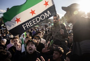 DAMASCUS, SYRIA - DECEMBER 13: People dance and sing songs as they take part in victory celebrations in Umayyad Square on December 13, 2024 in Damascus, Syria. Rebel forces in Syria have retaken the capital from longtime ruler Bashar al-Assad, who has fled the country for Moscow. The fall of the Assad regime marks a new chapter for Syria, which has been mired in a multi-party civil war since 2011, sparked by the Arab Spring uprisings. (Photo by Chris McGrath/Getty Images)