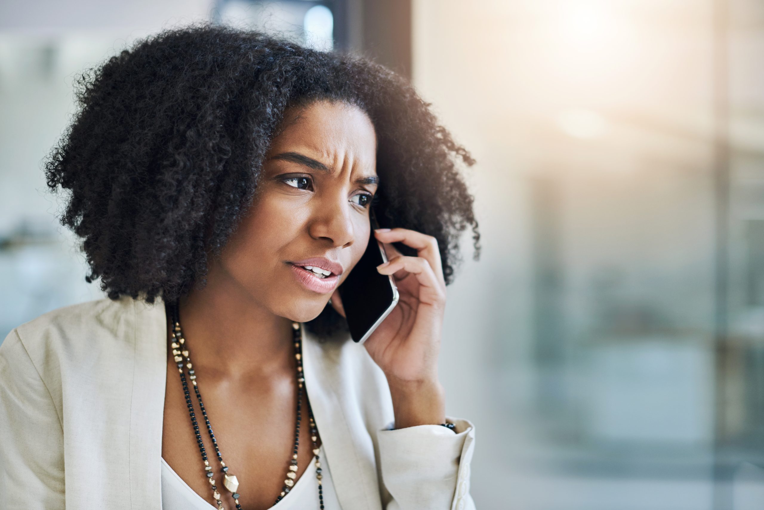 Shot of a young businesswoman making a phone call in her office