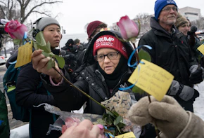 WASHINGTON, DC - JANUARY 6: A supporter of President-elect Donald Trump collects flowers during a memorial for Ashli Babbitt, who was killed on January 6, 2021, near the U.S. Capitol on January 6, 2025 in Washington, DC. The group laid flowers and called for the release of those imprisoned for their actions on January 6. (Photo by Nathan Howard/Getty Images)