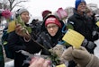WASHINGTON, DC - JANUARY 6: A supporter of President-elect Donald Trump collects flowers during a memorial for Ashli Babbitt, who was killed on January 6, 2021, near the U.S. Capitol on January 6, 2025 in Washington, DC. The group laid flowers and called for the release of those imprisoned for their actions on January 6. (Photo by Nathan Howard/Getty Images)