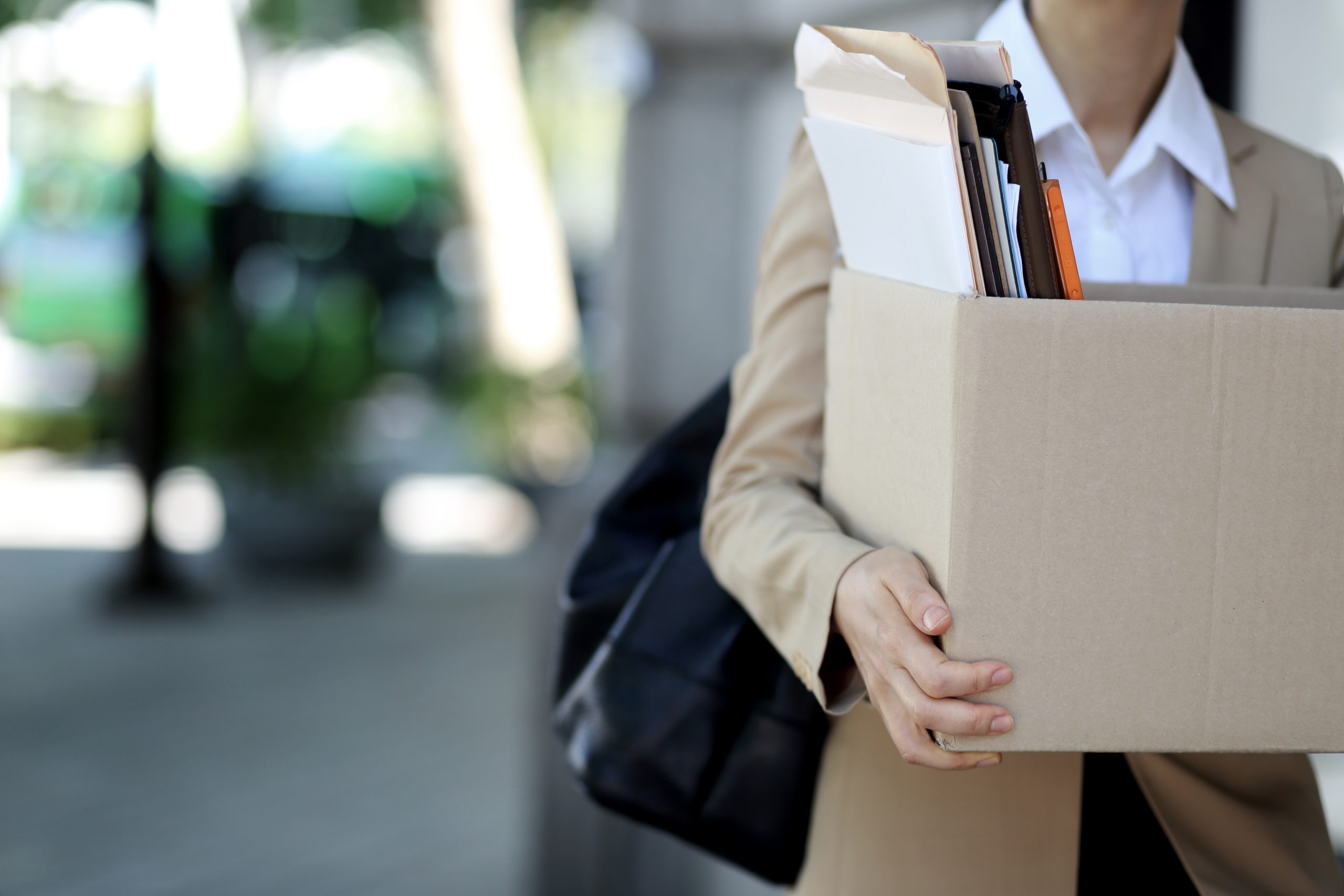 Close-up Of Businesswoman Standing With Cardboard Box Outside Office