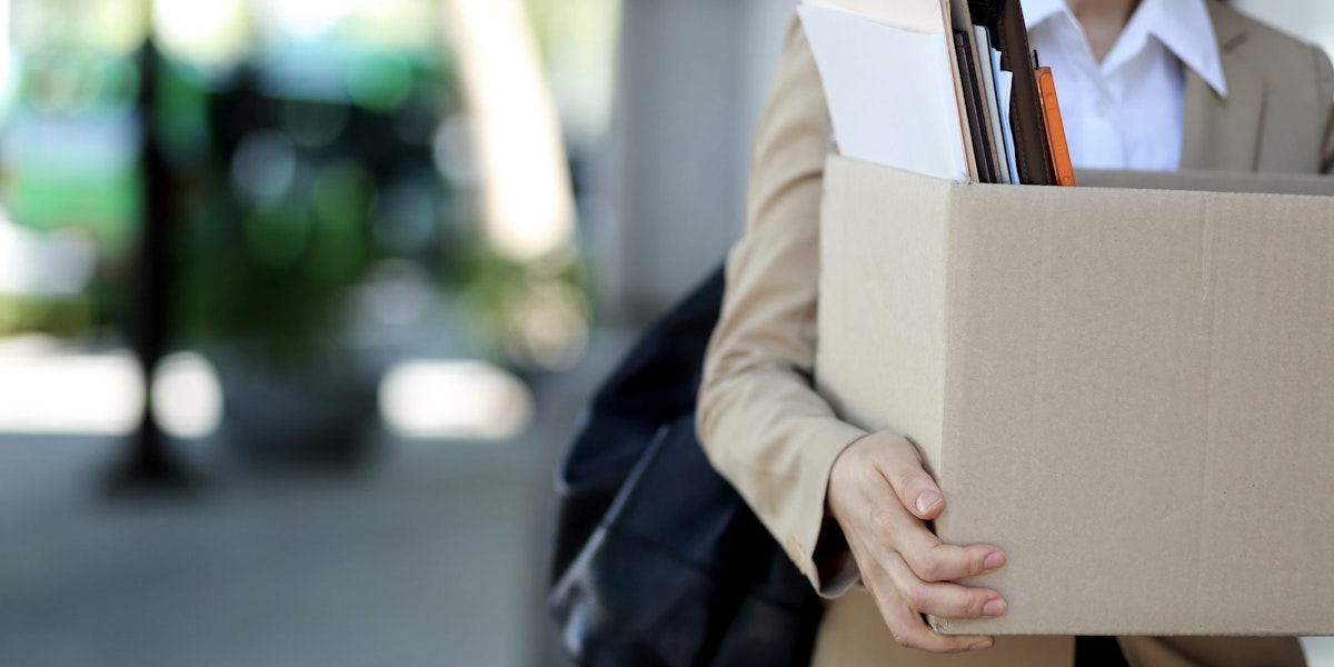 Close-up Of Businesswoman Standing With Cardboard Box Outside Office