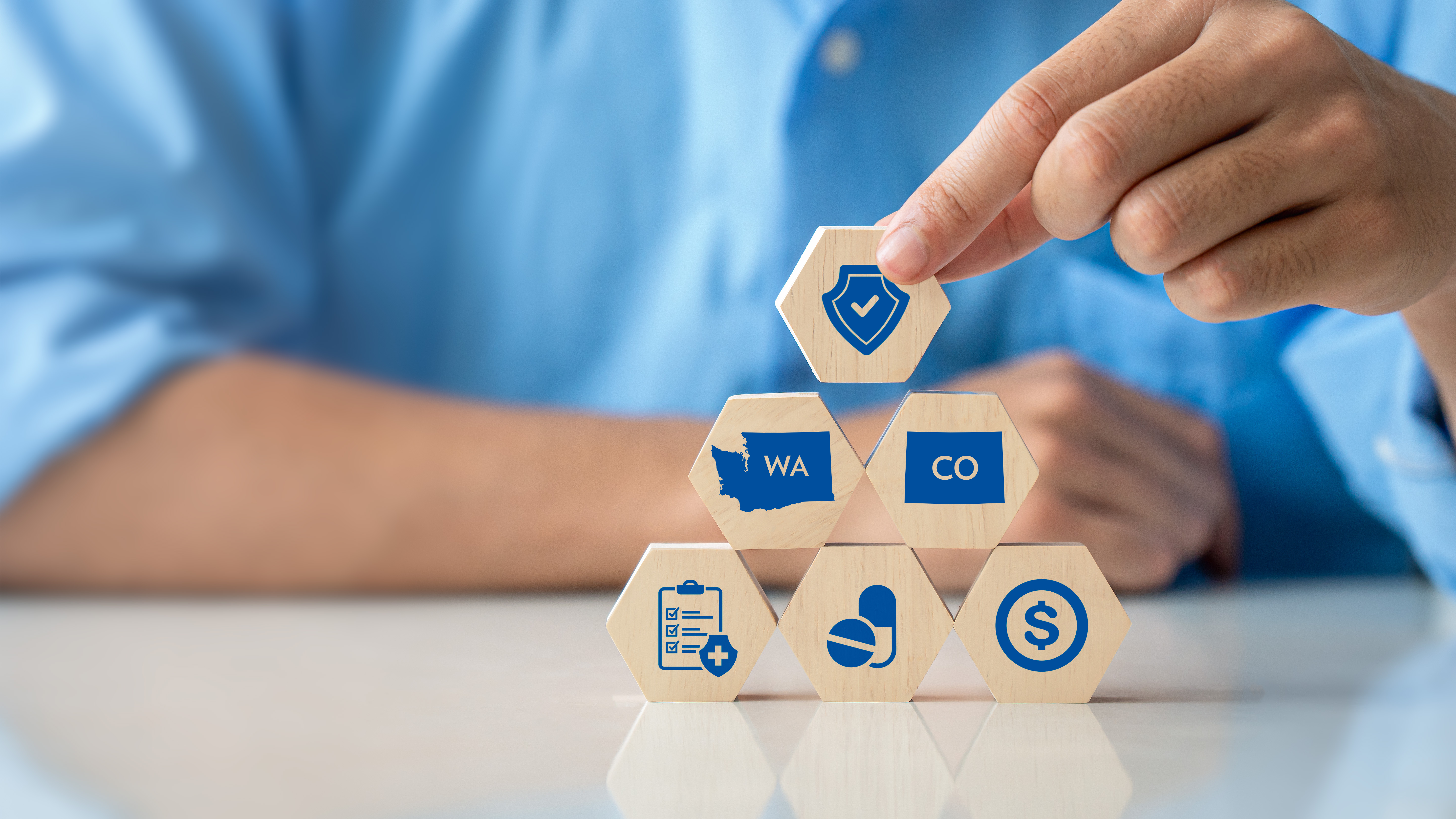 Person stacks up blacks that depict symbols commonly associated with healthcare