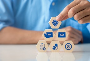 Person stacks up blacks that depict symbols commonly associated with healthcare