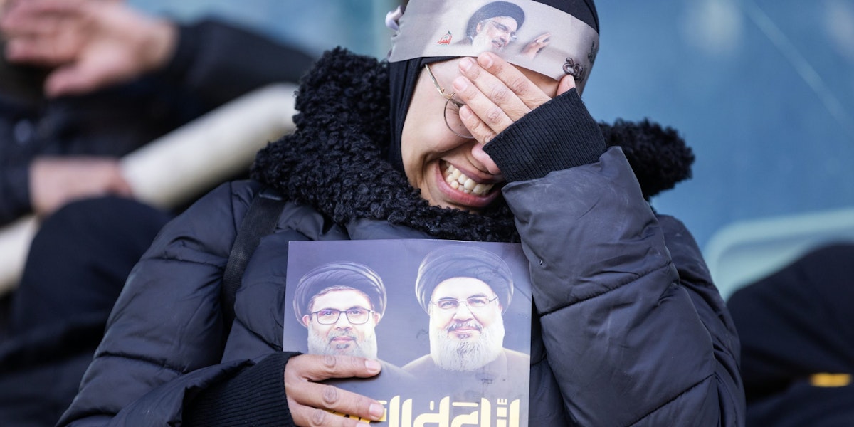 BEIRUT, LEBANON - FEBRUARY 23: A woman cries during the funerals for former Hezbollah leaders Hassan Nasrallah and Hashem Safieddine at the Sports City Stadium on February 23, 2025 in Beirut, Lebanon. Tens of thousands of people have gathered in Beirut to attend the funeral of Hezbollah's former leader, Hassan Nasrallah, nearly five months after he was killed in an Israeli airstrike on a southern suburb of the Lebanese capital. Nasrallah founded and led the Shi'ite Muslim group for 30 years, through decades of conflict with Israel and became one of the most prominent Arab figures in generations. (Photo by Daniel Carde/Getty Images)