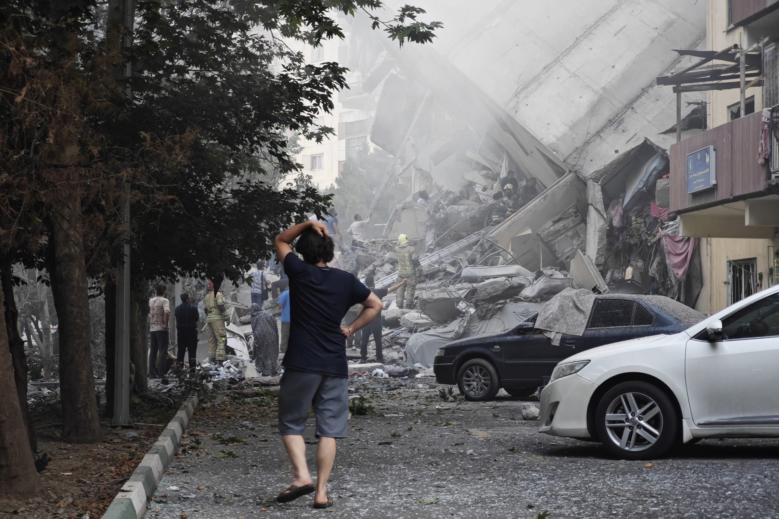 People look over damage to buildings in Nobonyad Square following Israeli airstrikes on June 13, 2025 in Tehran. Iran's three top military generals were killed in the attacks that also targeted nuclear and military facilities, according to published reports. Israel described the strikes as preemptive to keep Iran from obtaining nuclear weapons, the reports said. Source: Majid Saeedi/Getty Images