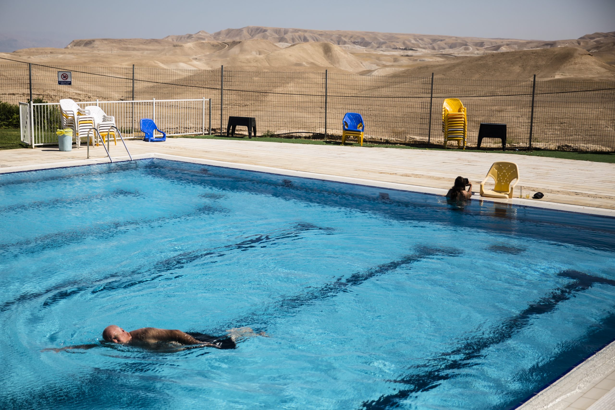 A Jewish Israeli man swims in a pool in the Israeli settlement of Vered Yericho in the West Bank Jordan Valley on June 24, 2020. Source: Amir Levy/Getty Images
