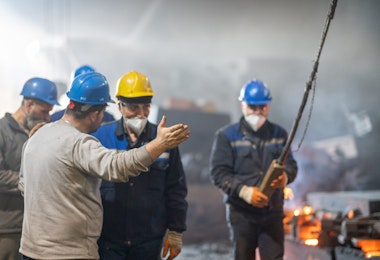 Workers discussing inside factory