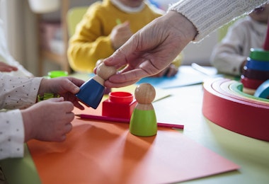 Preschool children playing with colorful shapes