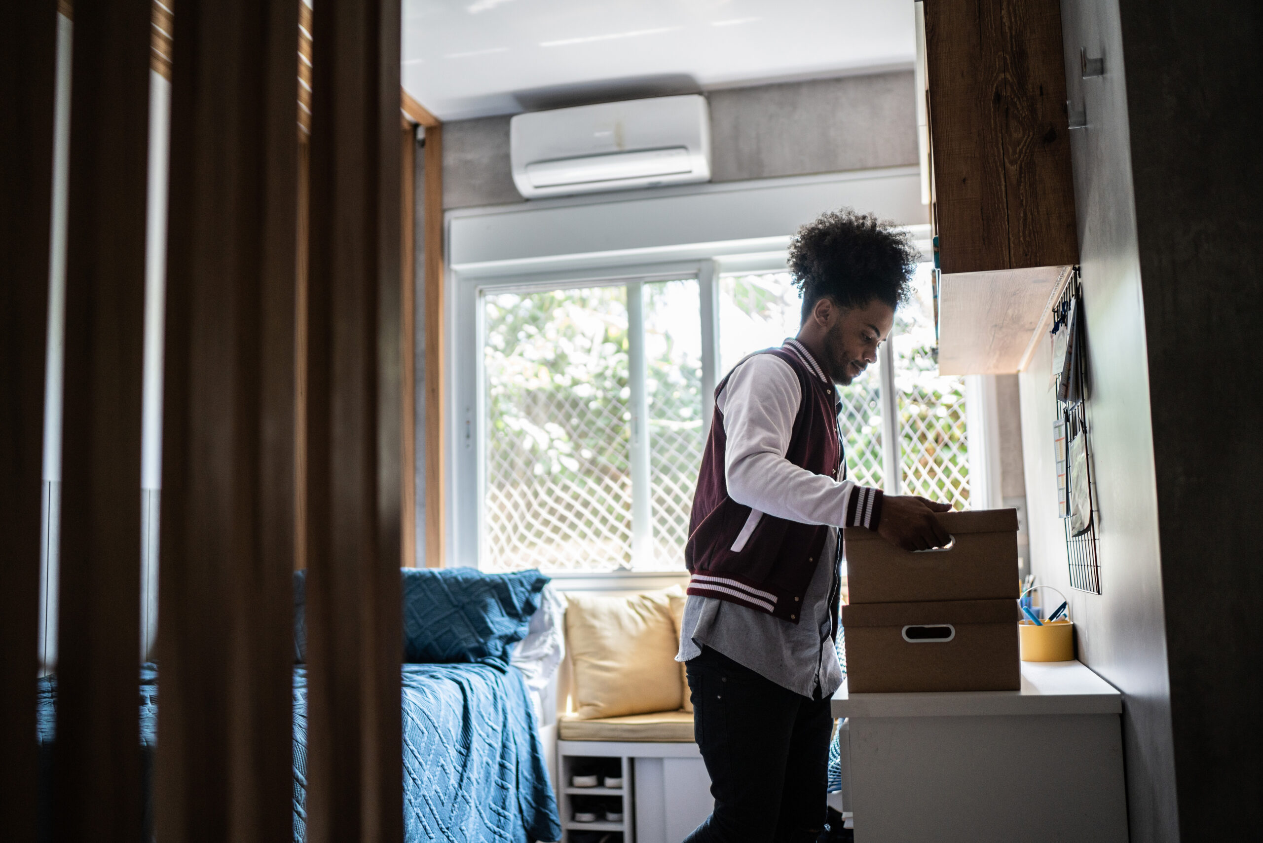 Young man packing belongings