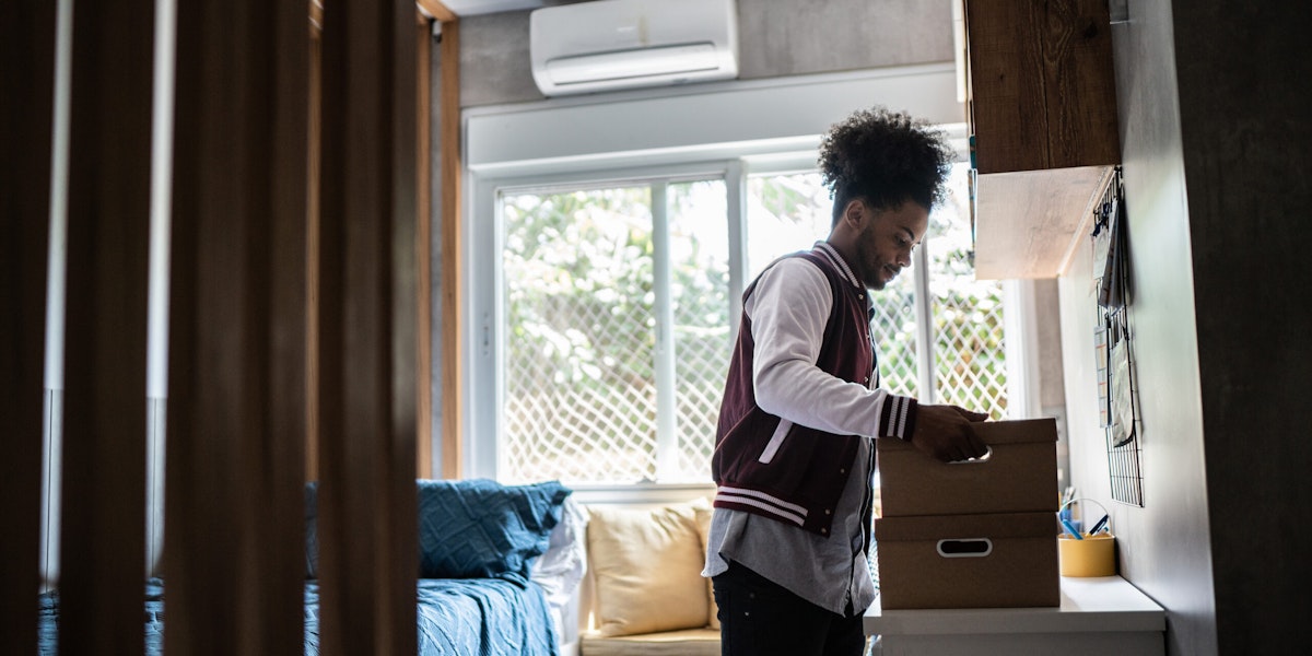 Young man packing belongings