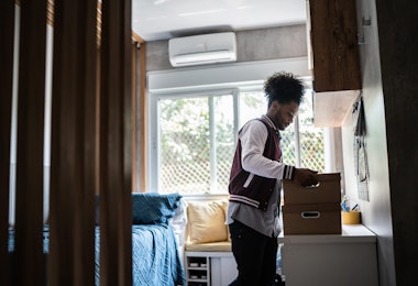 Young man packing belongings