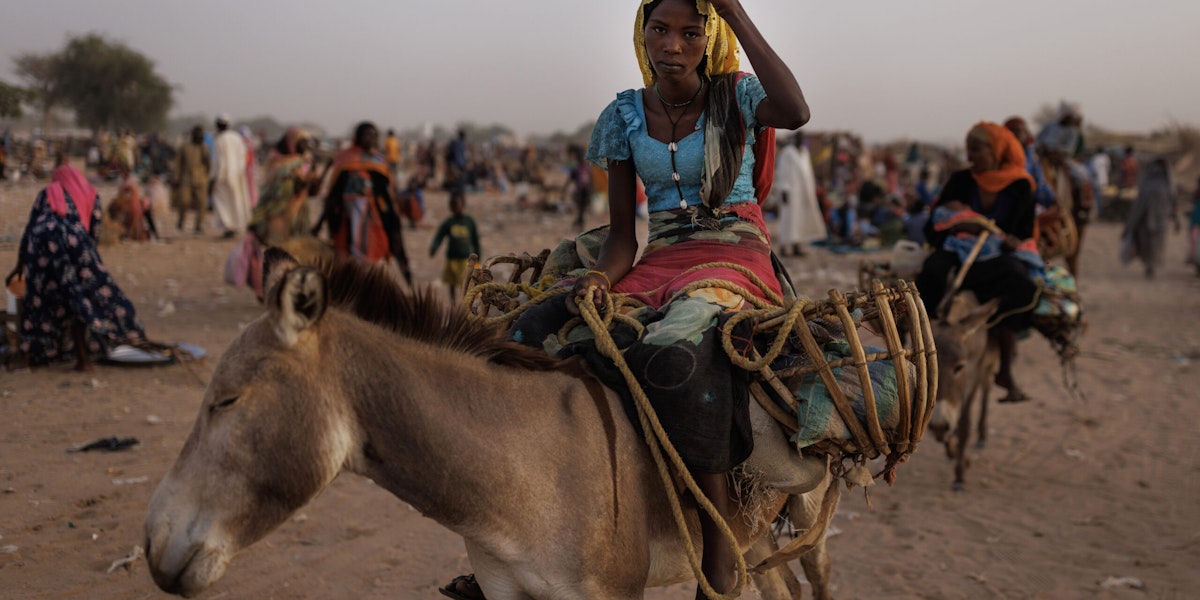 ADRE, CHAD - APRIL 24: Newly arrived refugee from Darfur in Sudan, sit on donkey as they head to their shelters on April 24, 2024 in Adre, Chad. Since the beginning of the recent conflict between the paramilitary Rapid Support Forces (RSF) and the the Sudanese Armed Forces, (SAF), which began in March 2023, over 600,000 new refugees have crossed the border from Darfur in Sudan, into Chad. The total number of refugees, including those from previous conflicts, now stands at 1.2 million. Aid agencies, including The World Food Programme, (WFP), Médecins Sans Frontières (MSF) and the United Nations High Commissioner for Refugees, (UNHCR), already struggling with acute supply shortages, have warned that the life-saving programmes in Chad, will ‘grind to a halt in a matter of weeks without urgent funding’. Chad is now home to one of the largest and fastest-growing refugee populations in Africa. (Photo by Dan Kitwood/Getty Images)