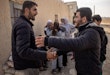 DAMASCUS, SYRIA - DECEMBER 21: Ahmed Muhammad Al-Nawa (L) is greeted by a neighbourhood friend after returning home from Lebanon to his family’s home in the village of Harran for the first time in 10-years on December 21, 2024 in Damascus, Syria. 36-year-old Ahmed, was imprisoned and tortured by the regime for a year and half in the Mezzah Military Prison in 2012-2013, after his release, his wife and daughter were displaced from their home in the village of Harran, Eastern Ghouta, Damascus, during the Assad regime’s siege of the region in 2014. They fled to Lebanon where they have been living in a tent in the Hosh Al-Hareem camp for the past 10-years. Ahmed’s mother Umm Marwan stayed behind in Syria due to a heart condition that stopped her from travelling. While living in Lebanon, Ahmed and his wife had four more children that were born in Lebanon and have never meet their grandmother, other relatives or seen the family home. After the fall of the regime Ahmed decided to return home bringing all his possessions from Lebanon and giving his mother the chance to meet her grandchildren face to face for the first time. (Photo by Chris McGrath/Getty Images)