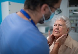 Senior woman being checked by endocrinologist in clinic.