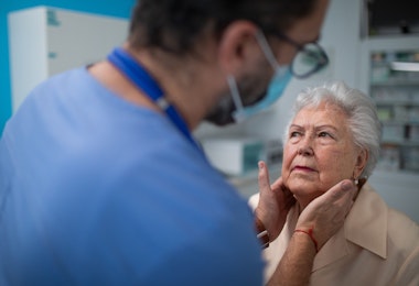Senior woman being checked by endocrinologist in clinic.
